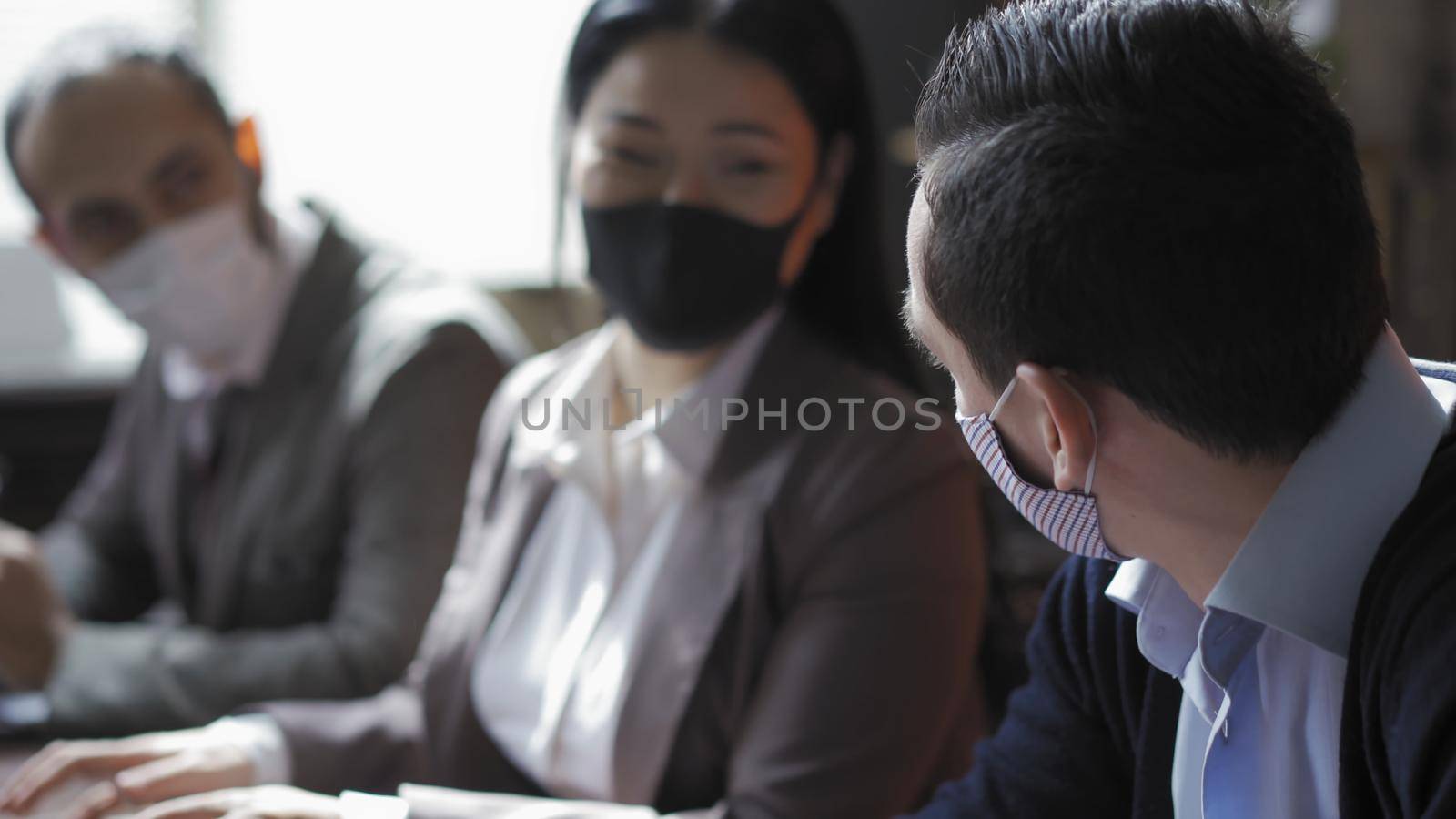 Business People Working Work In Protective Masks In Office by LipikStockMedia