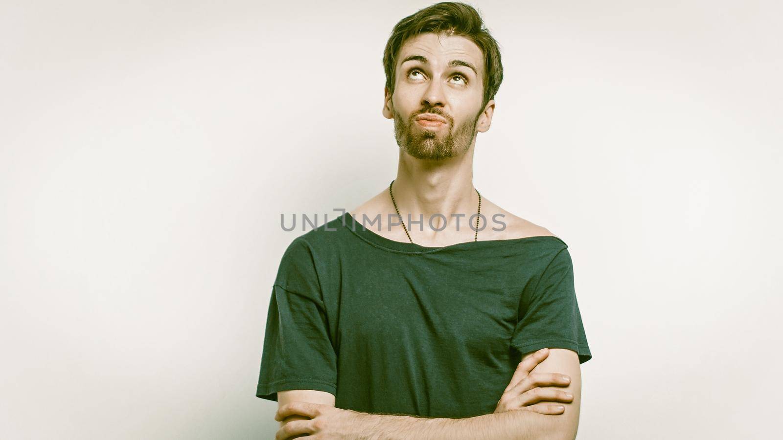 Caucasian Man Stands With Crossed Arms Looking Up by LipikStockMedia