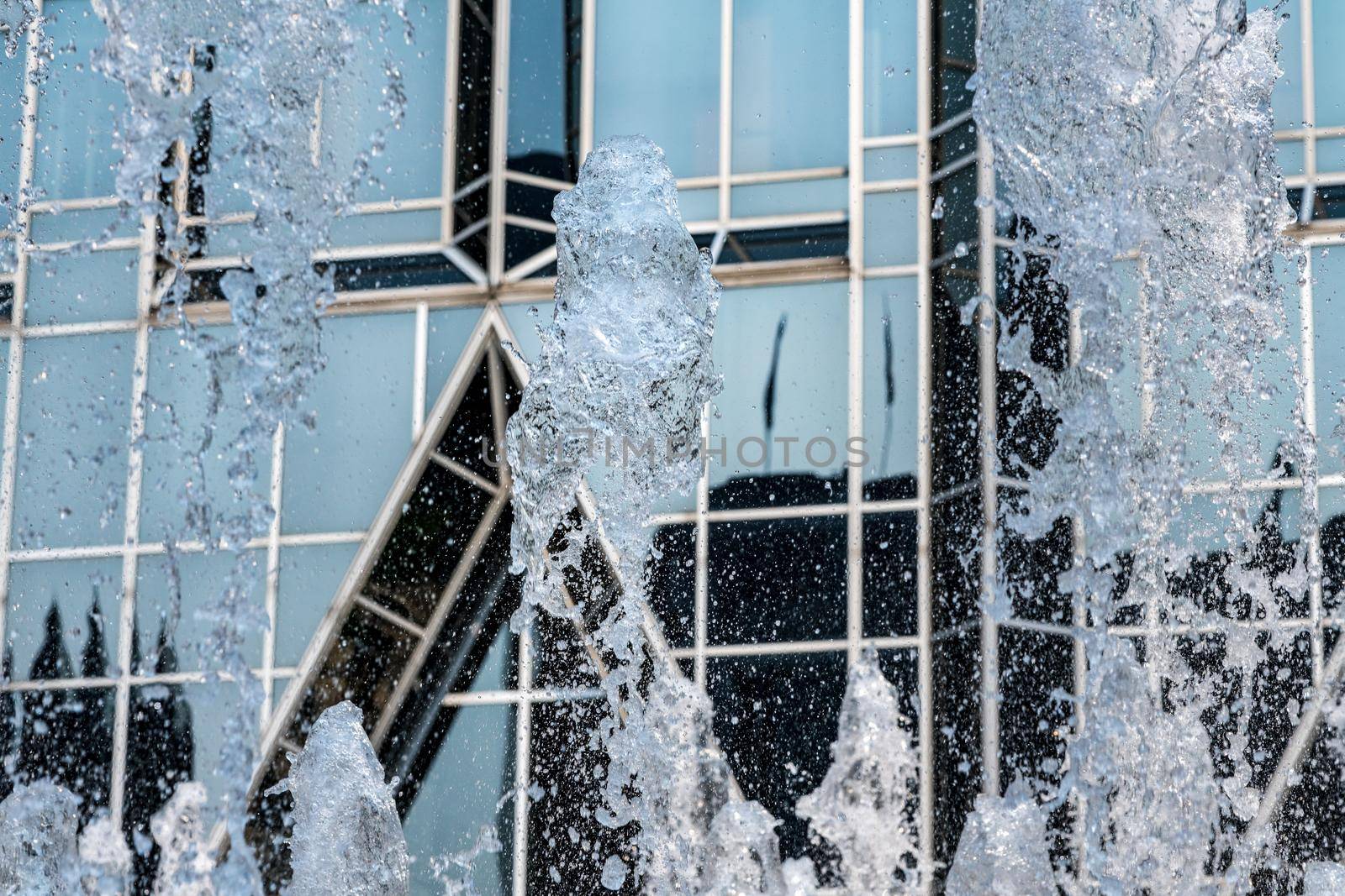 Frozen water from fountain in front of reflective office building in downtown Pittsburgh
