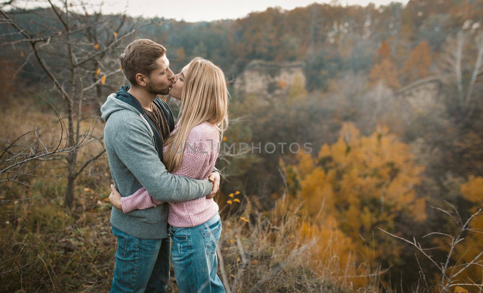 Hugs And Kisses Of Couple In Love Outdoors by LipikStockMedia