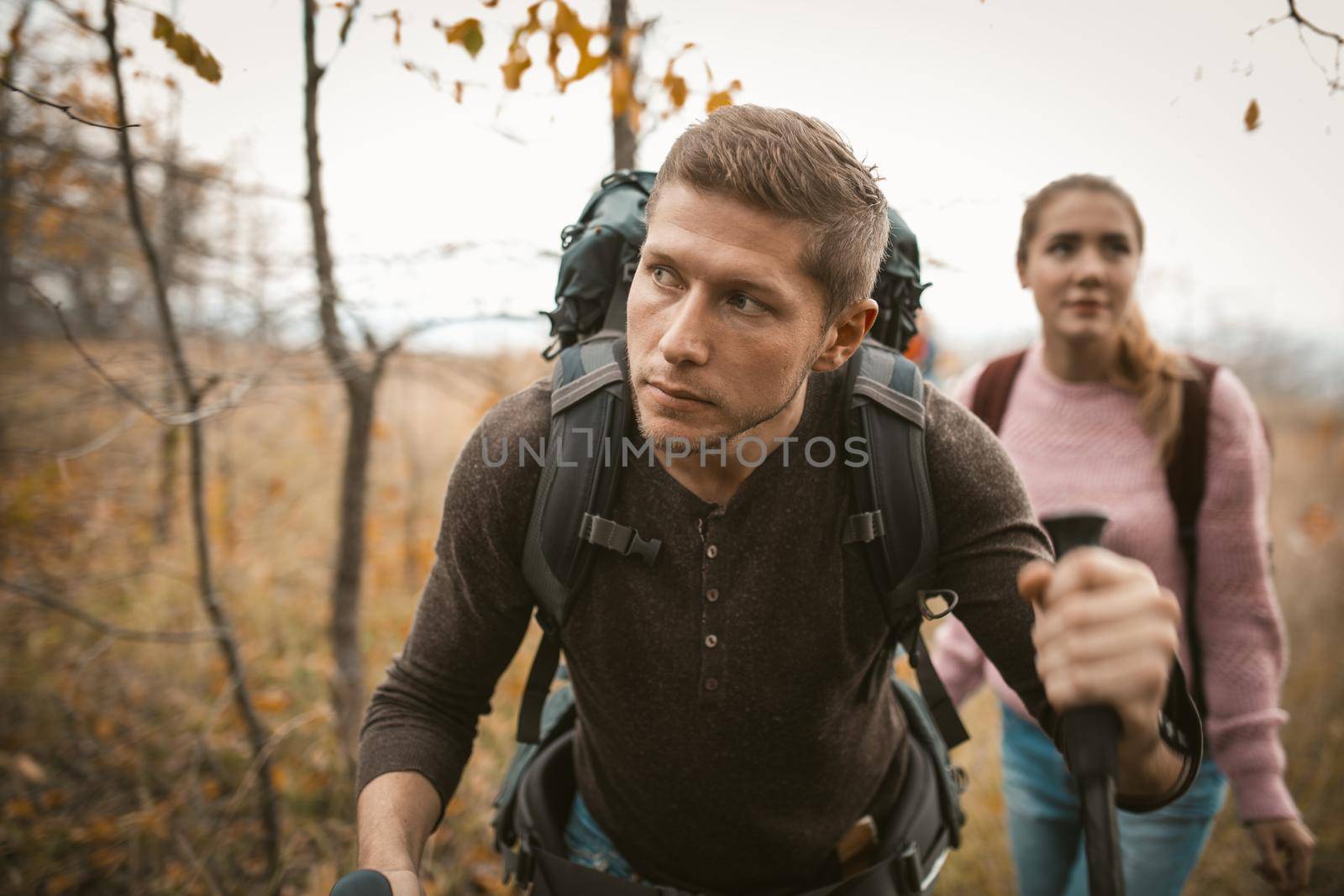 Traveling Couple With Backpacks Hiking Outdoors by LipikStockMedia