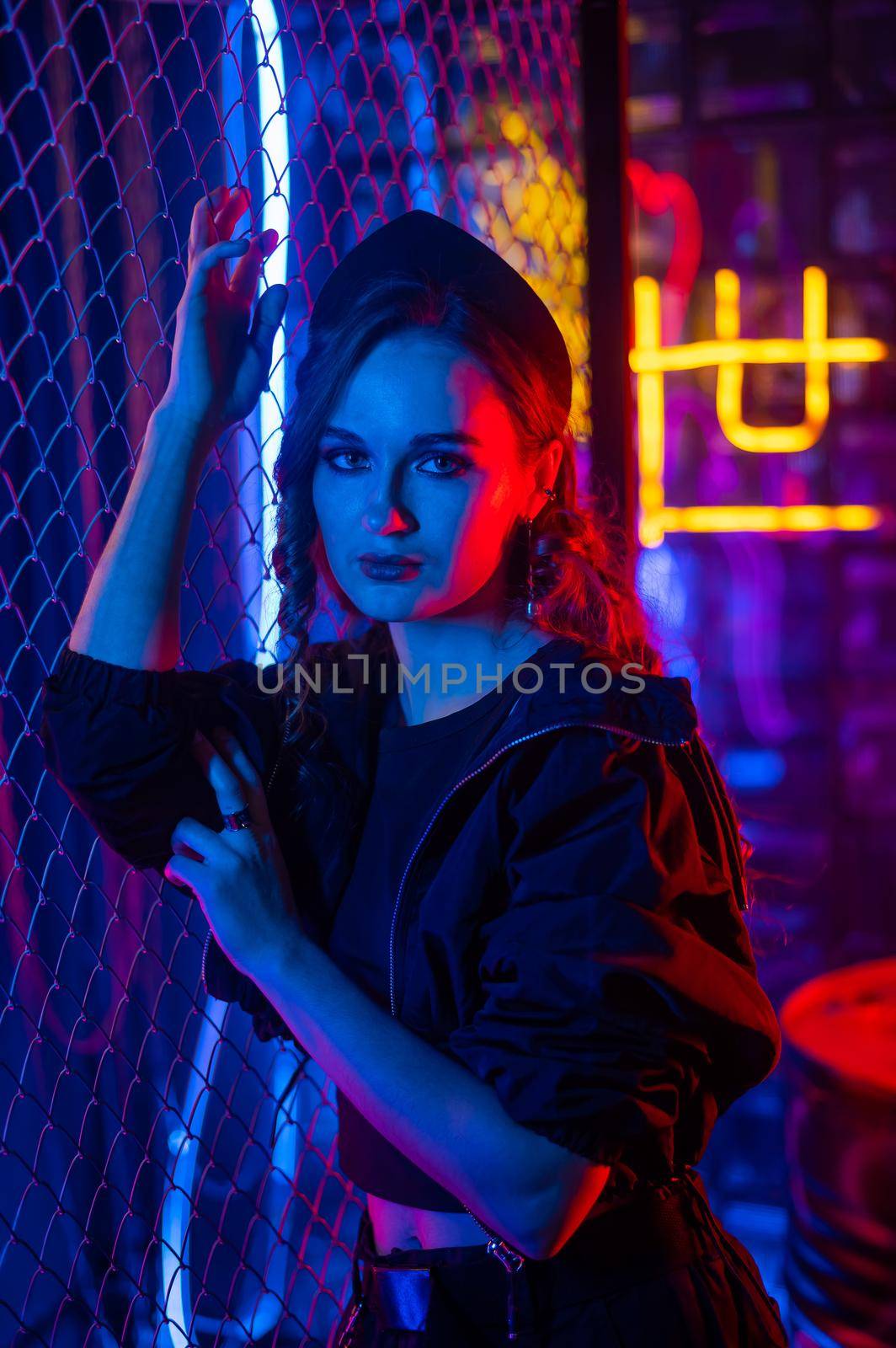 Caucasian woman posing in neon studio