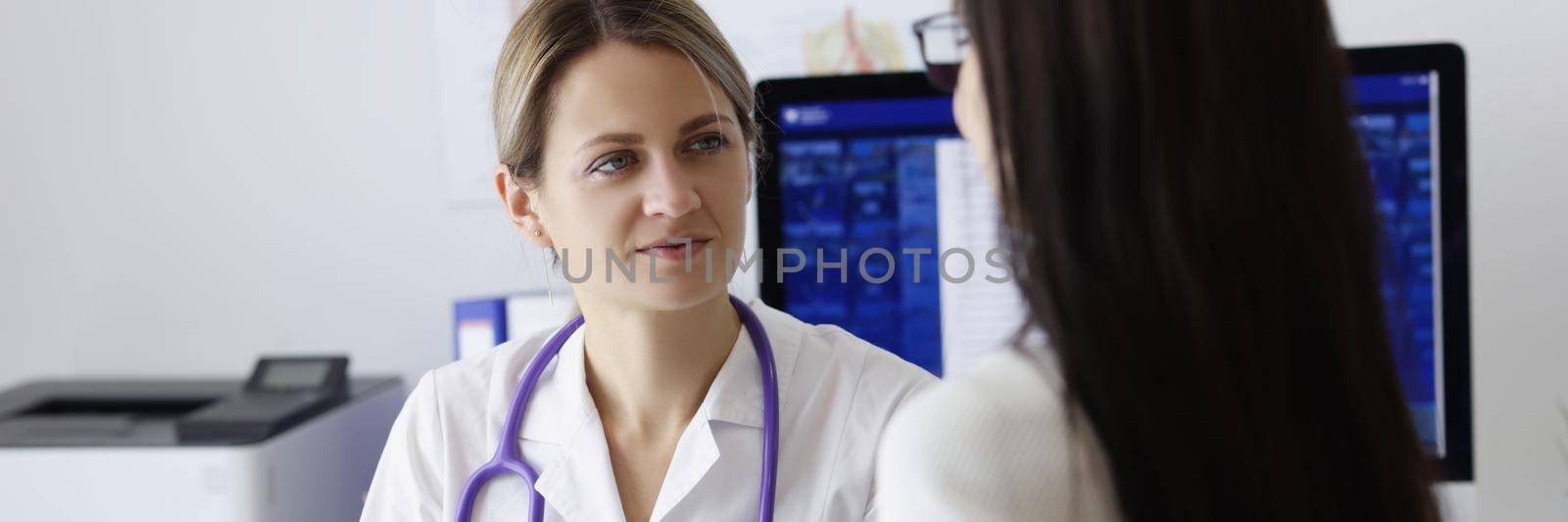Portrait of patient on appointment explain problem to medical worker in clinic. Female doctor listen to complaints. Health, medicine, diagnostic concept