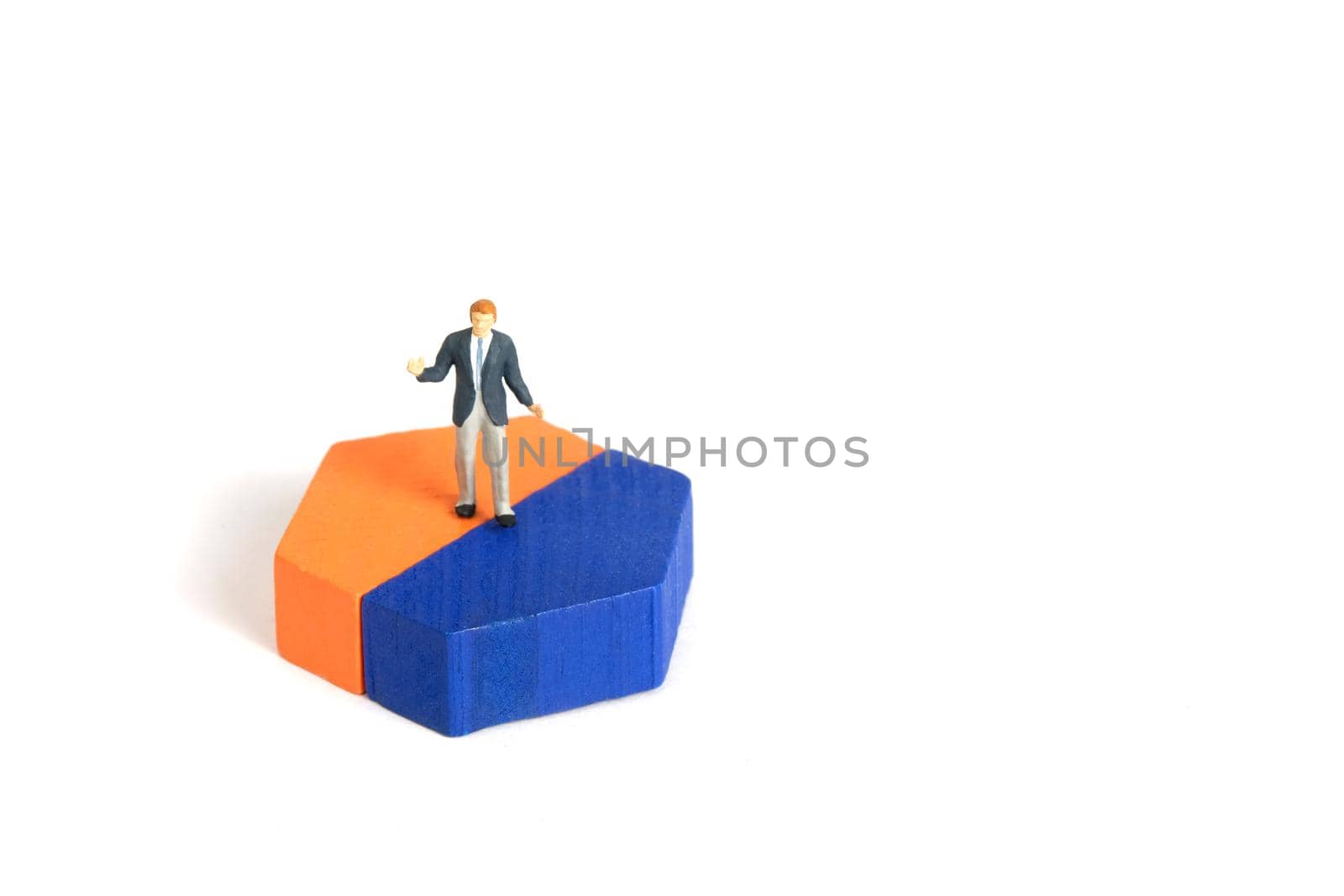 Miniature people toy figure photography. A shrugging businessman doing business presentation standing above wooden chart diagram. Isolated on white background. Image photo