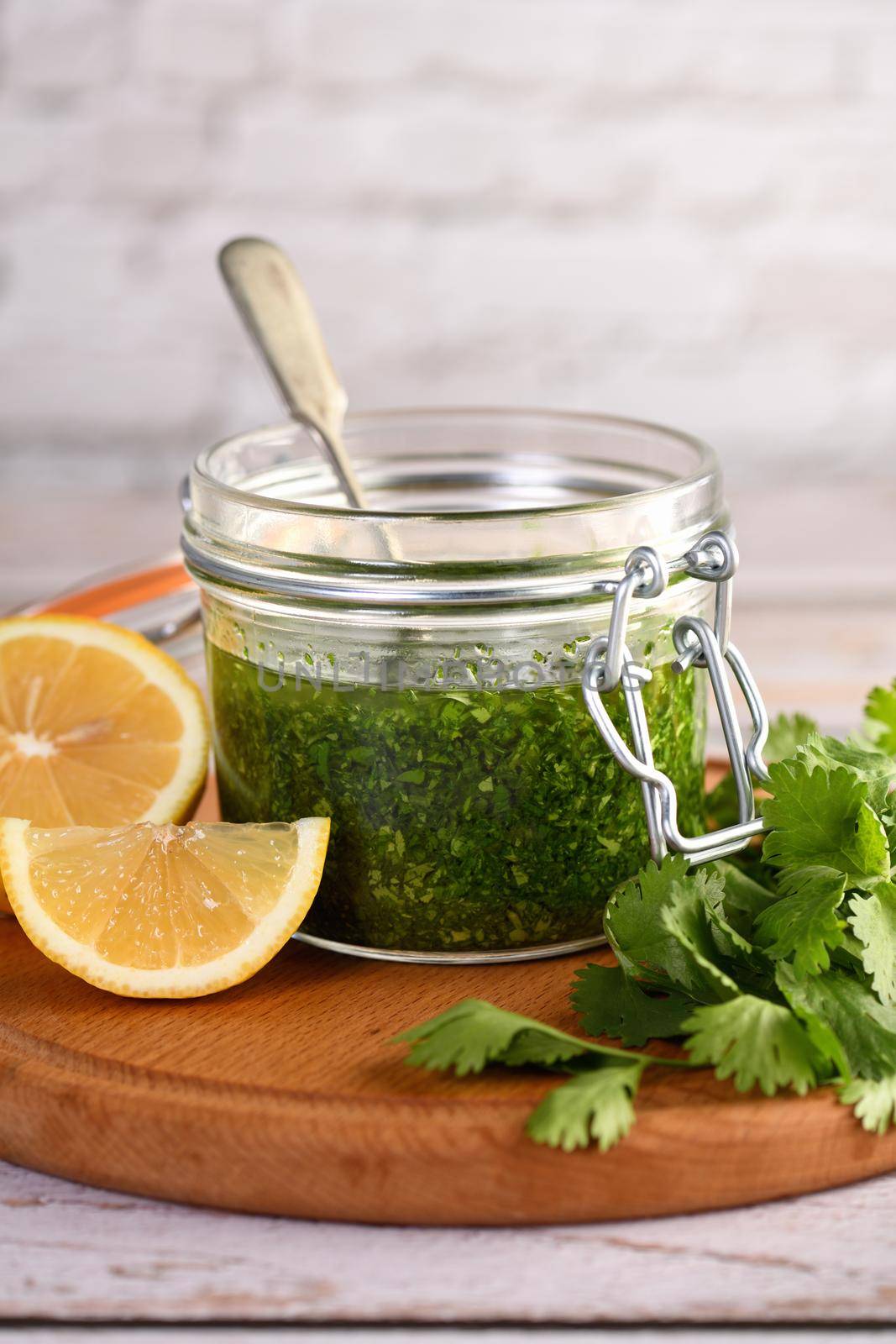 Green delicious herbal marinade of cilantro, basil, parsley, oil, traditional seasoning for salad dressing