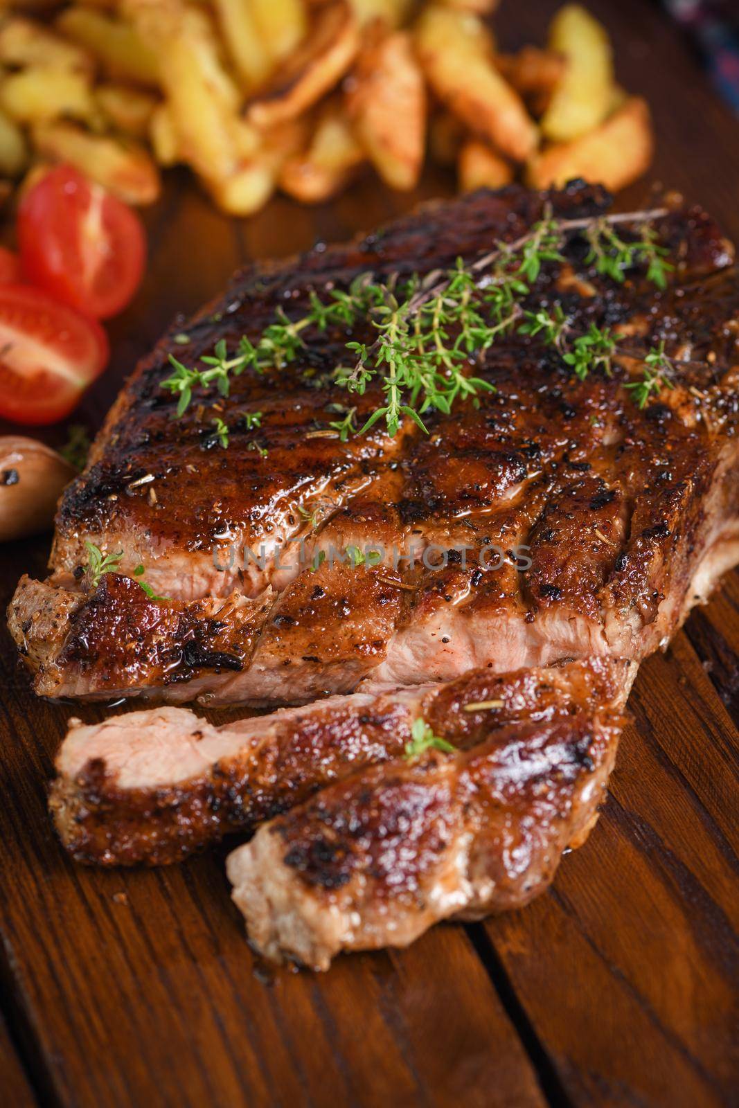 Sliced fried pork steak on a wooden board  by Apolonia