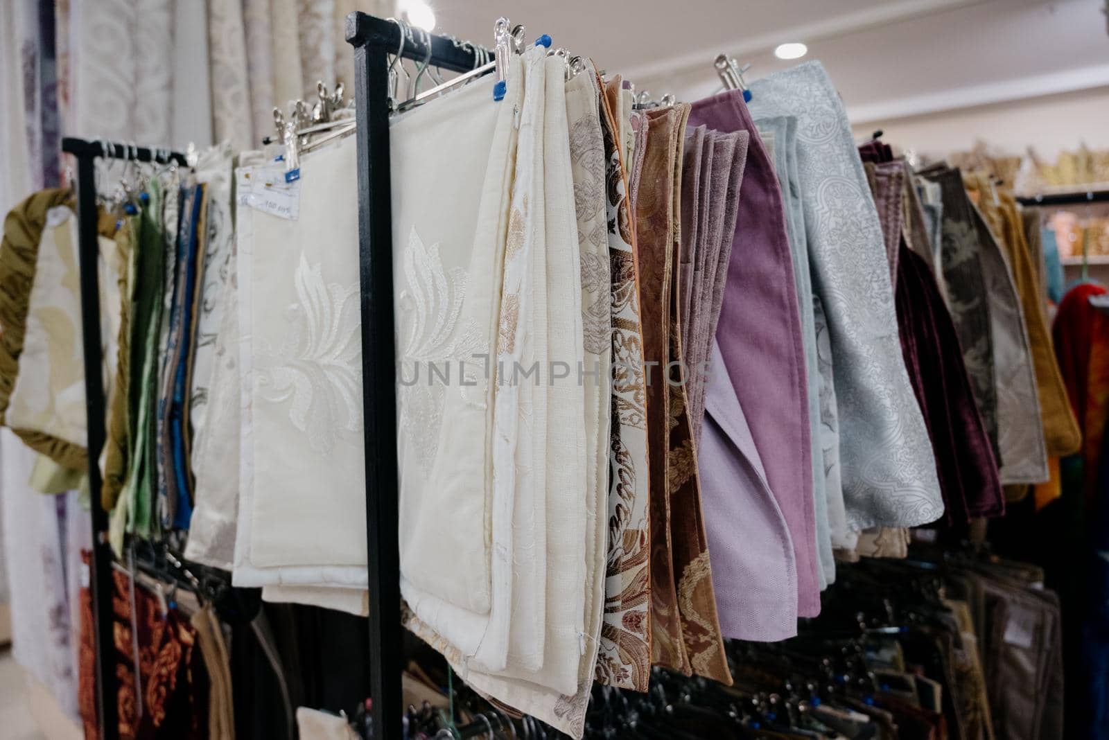 A row of colorful pillowcases on a shelf in a textile store.Many colorful pillowcases are sold in the shopping center