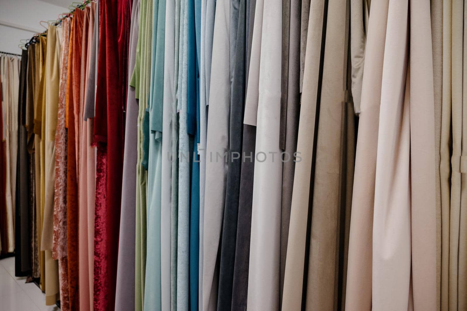 Collection of curtains in different colors and patterns. Salon curtains.Different types of curtains close-up.Curtain background
