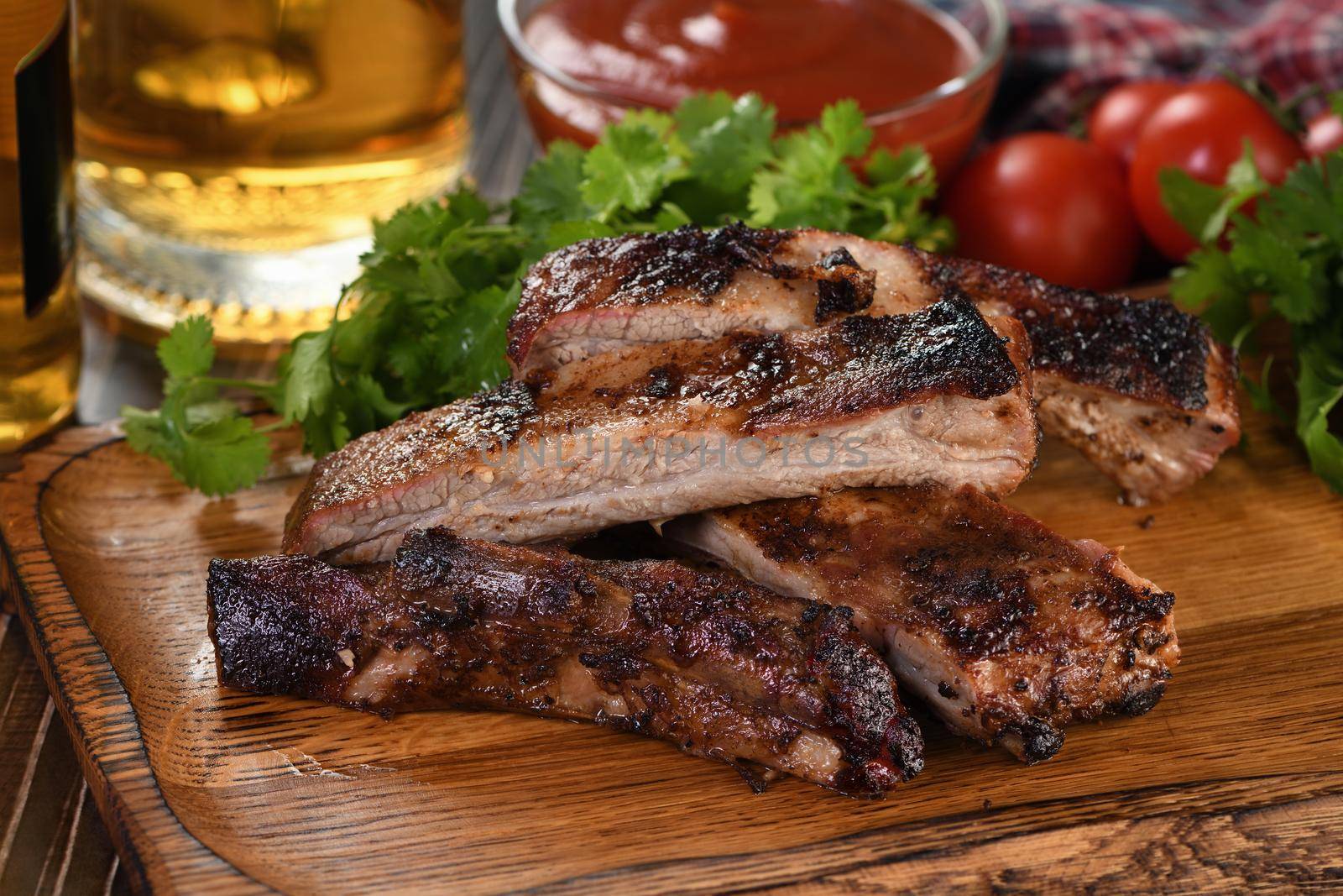Delicious Baked Grilled Sliced pork belly with barbeque  sauce plating on wooden plate,  herbs and vegetables
