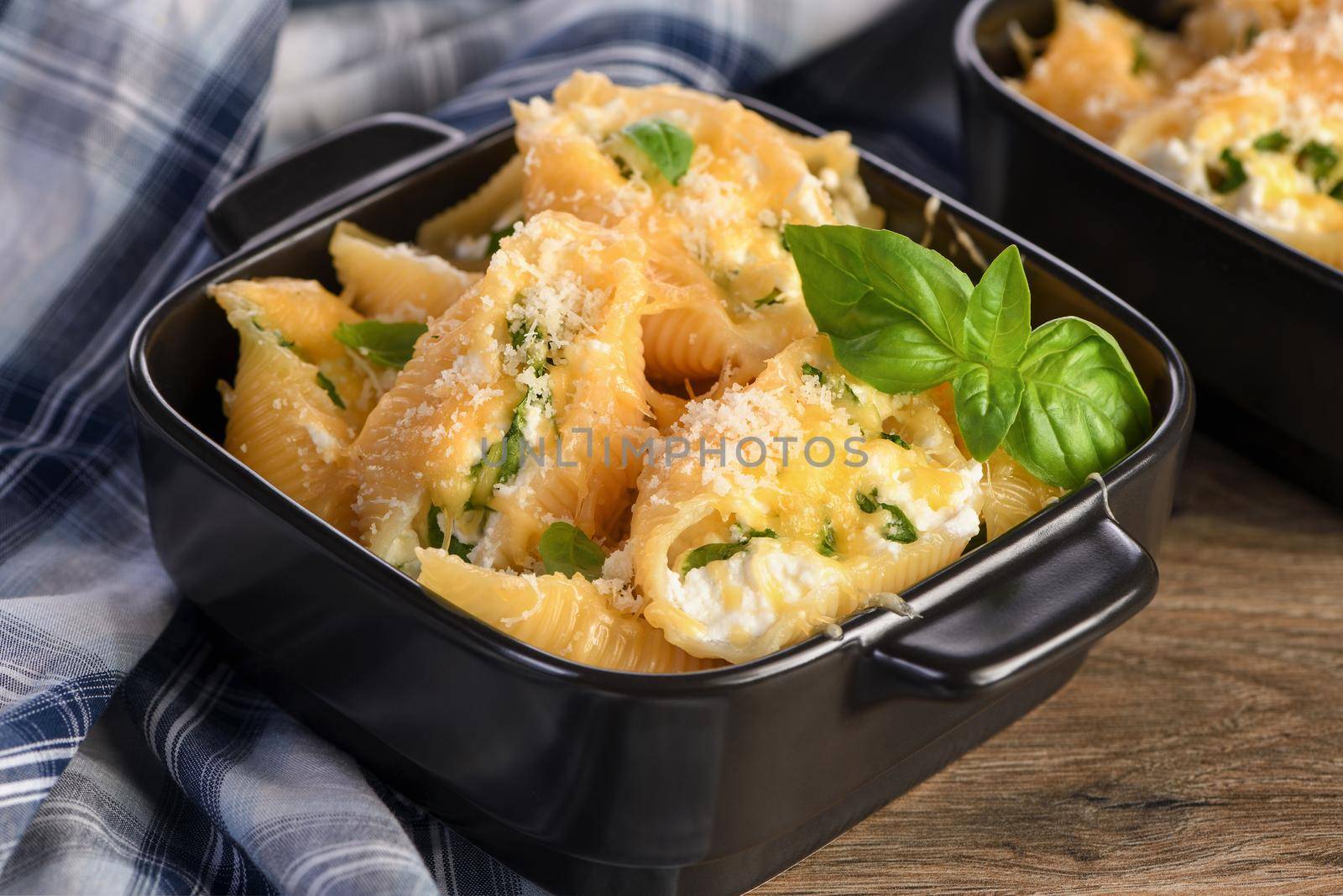 Pasta Сonchiglioni stuffed with spinach, ricotta and parmesan baked
