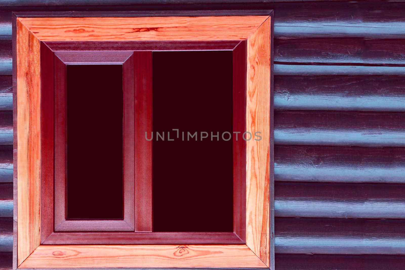 an opening in the wall of a building or vehicle that is fitted with glass or other transparent material in a frame.Black window in a wooden brown frame in a wooden wall of blue brown logs timbers.