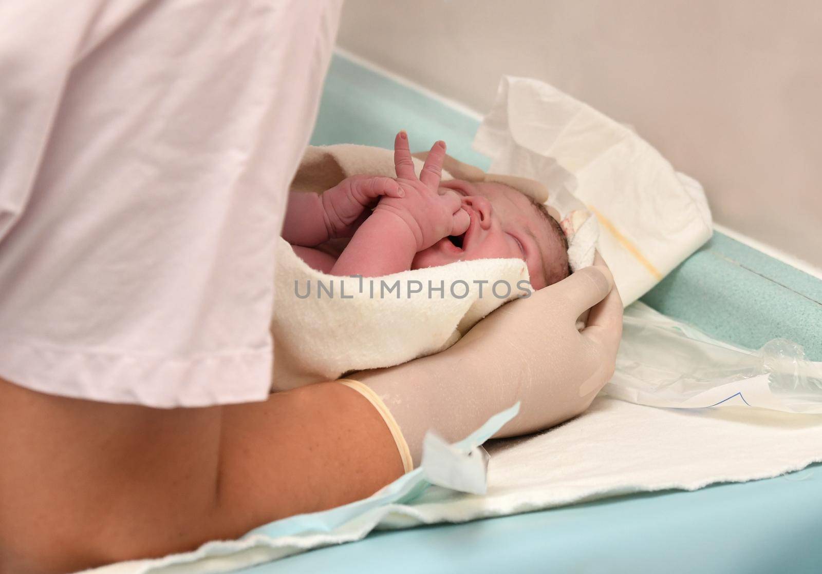 Nurse caring for newborn after childbirth