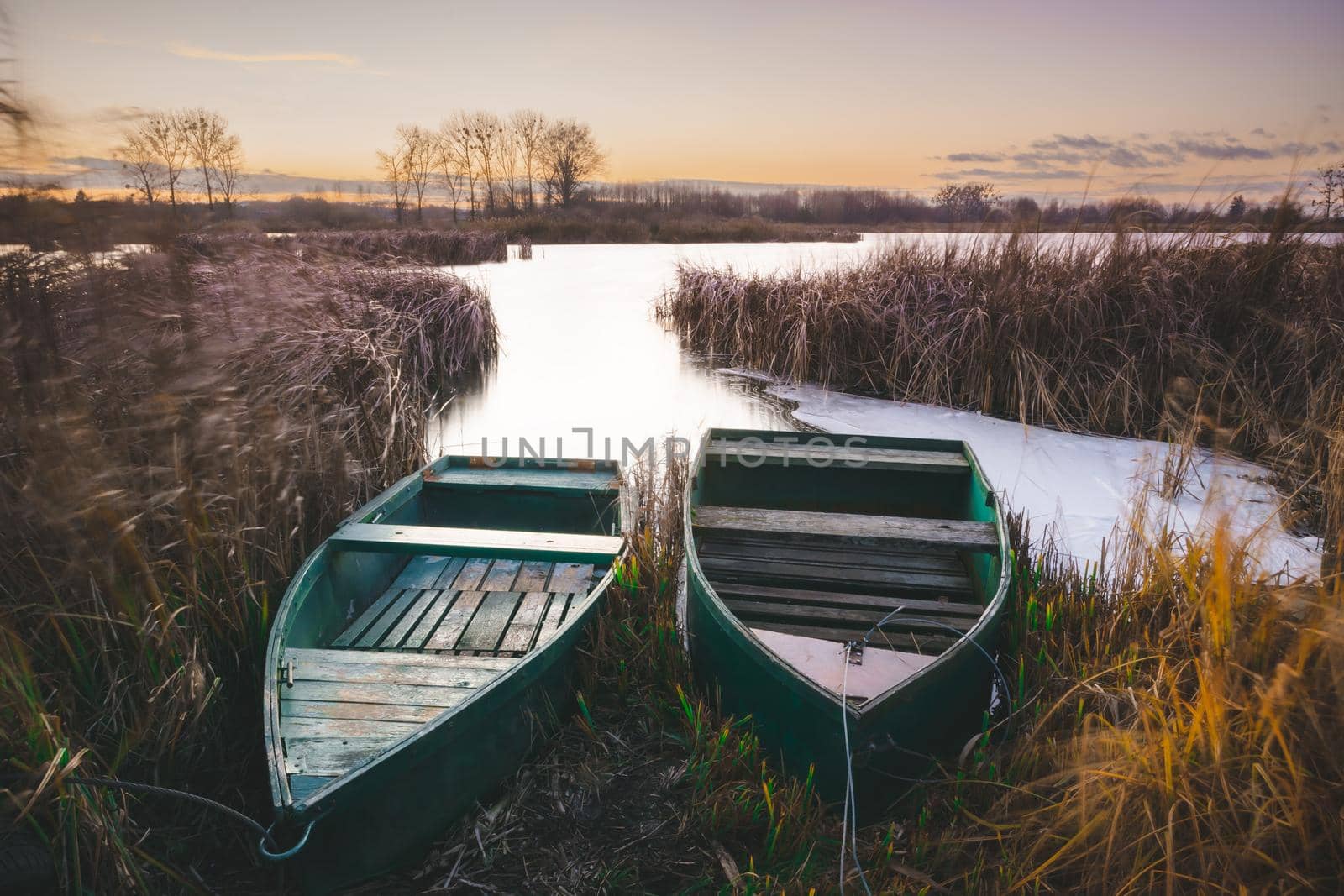 Two boats on the shore of the lake, evening view