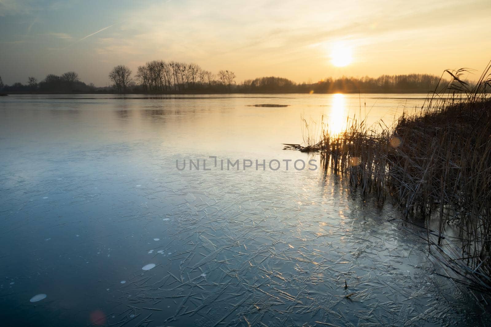 View on a frozen lake during sunset, Stankow, Poland