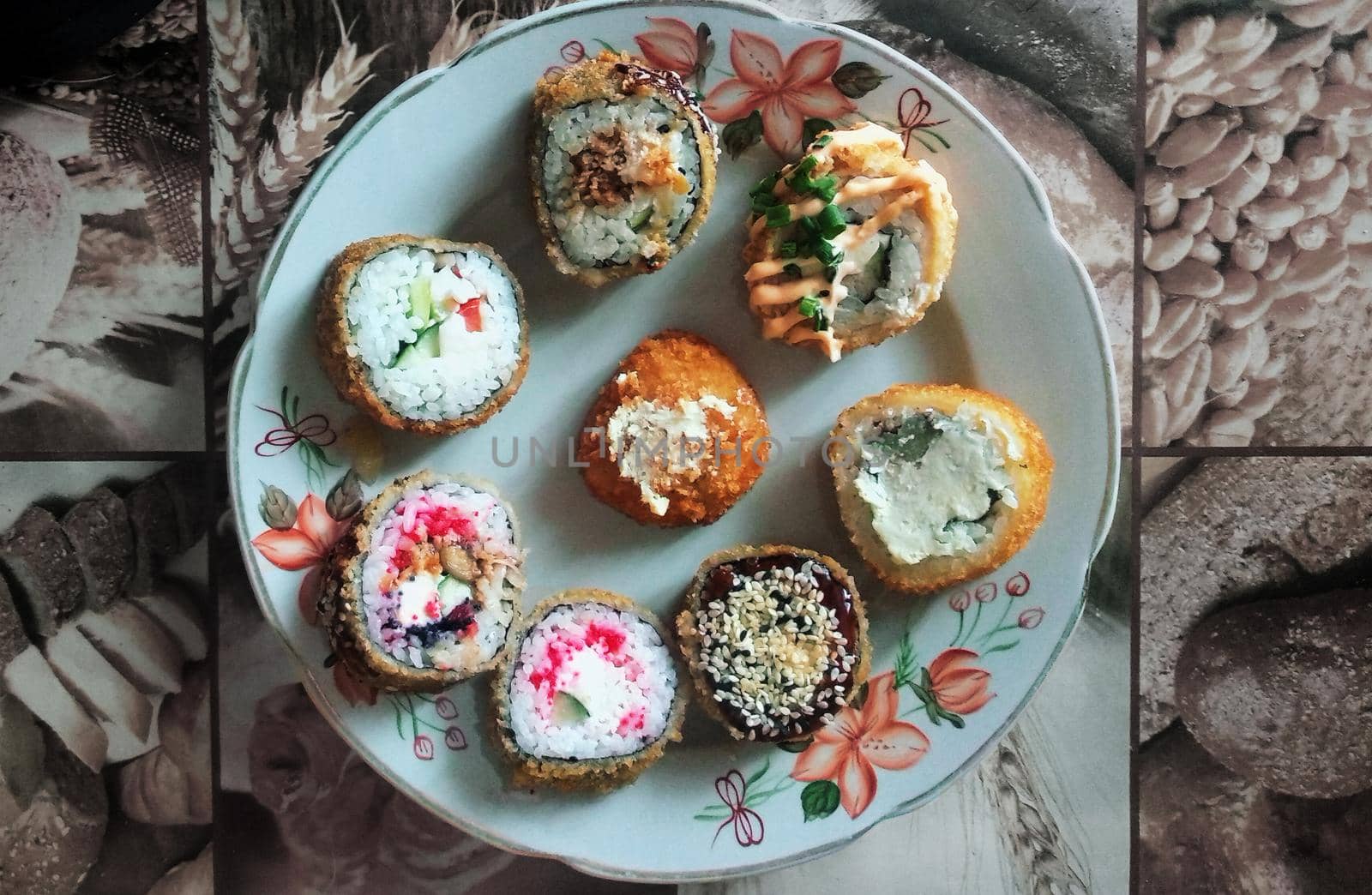 Different types of sushi on a white tablecloth plate with drawings