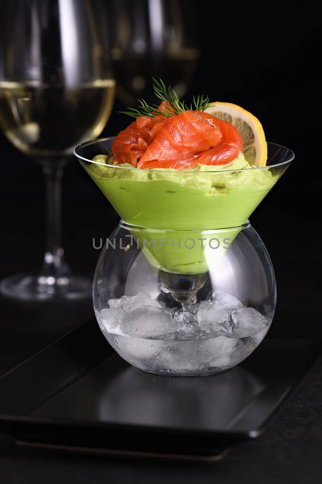 Taste is a combination of avocado pulp with a delicate texture of soft  cheese cream and salmon, with the addition of dill and a slice of lemon. Serving verrine in a Martini Chiller with ice. Aperitif appetizer