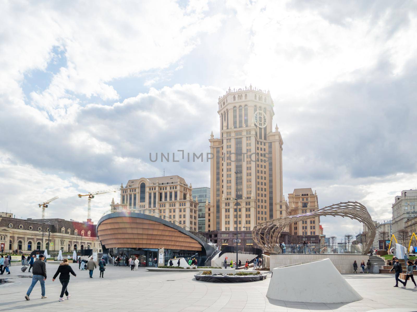 MOSCOW, RUSSIA - May 01, 2022. Local people and tourists walk on square near Paveletsky railway. Modern urban architecture.