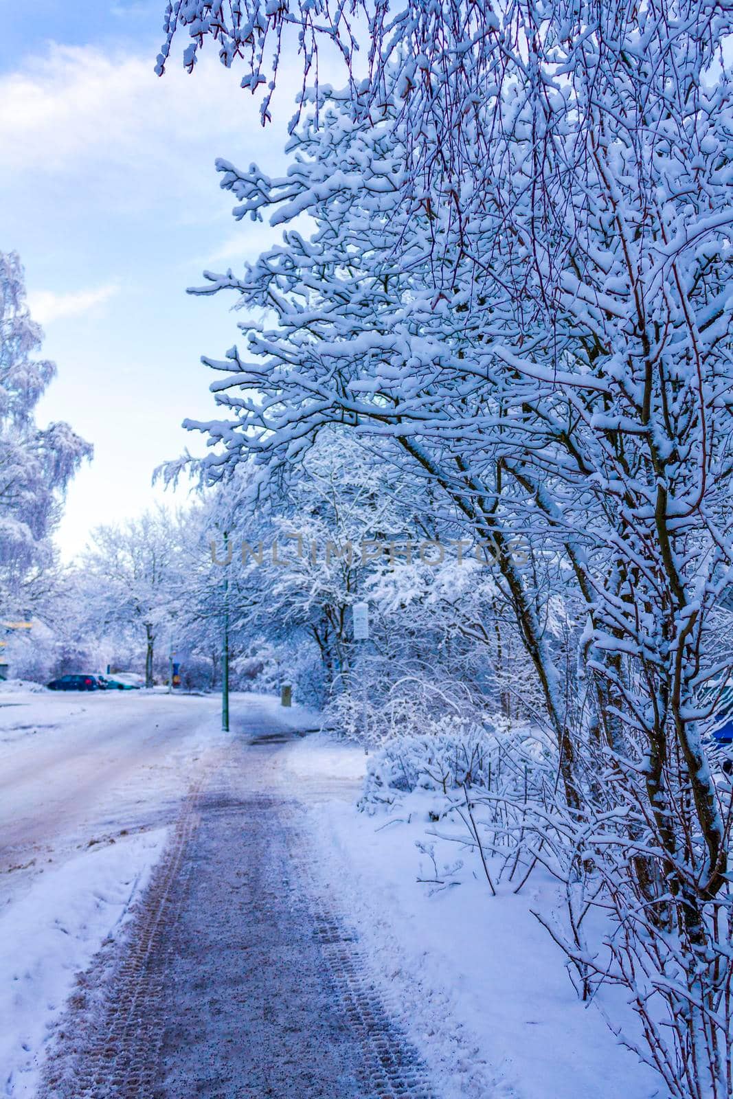 Amazing beautiful snowy winter snow and ice landscape panorama view with trees blue sky and town in Leherheide Bremerhaven Bremen Germany.