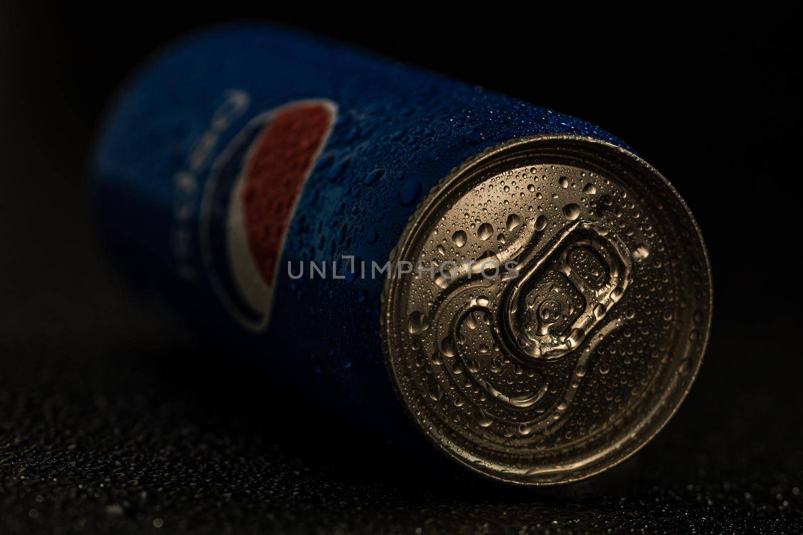 Editorial photo of Pepsi can with water droplets on black background. Studio shot in Bucharest, Romania, 2021