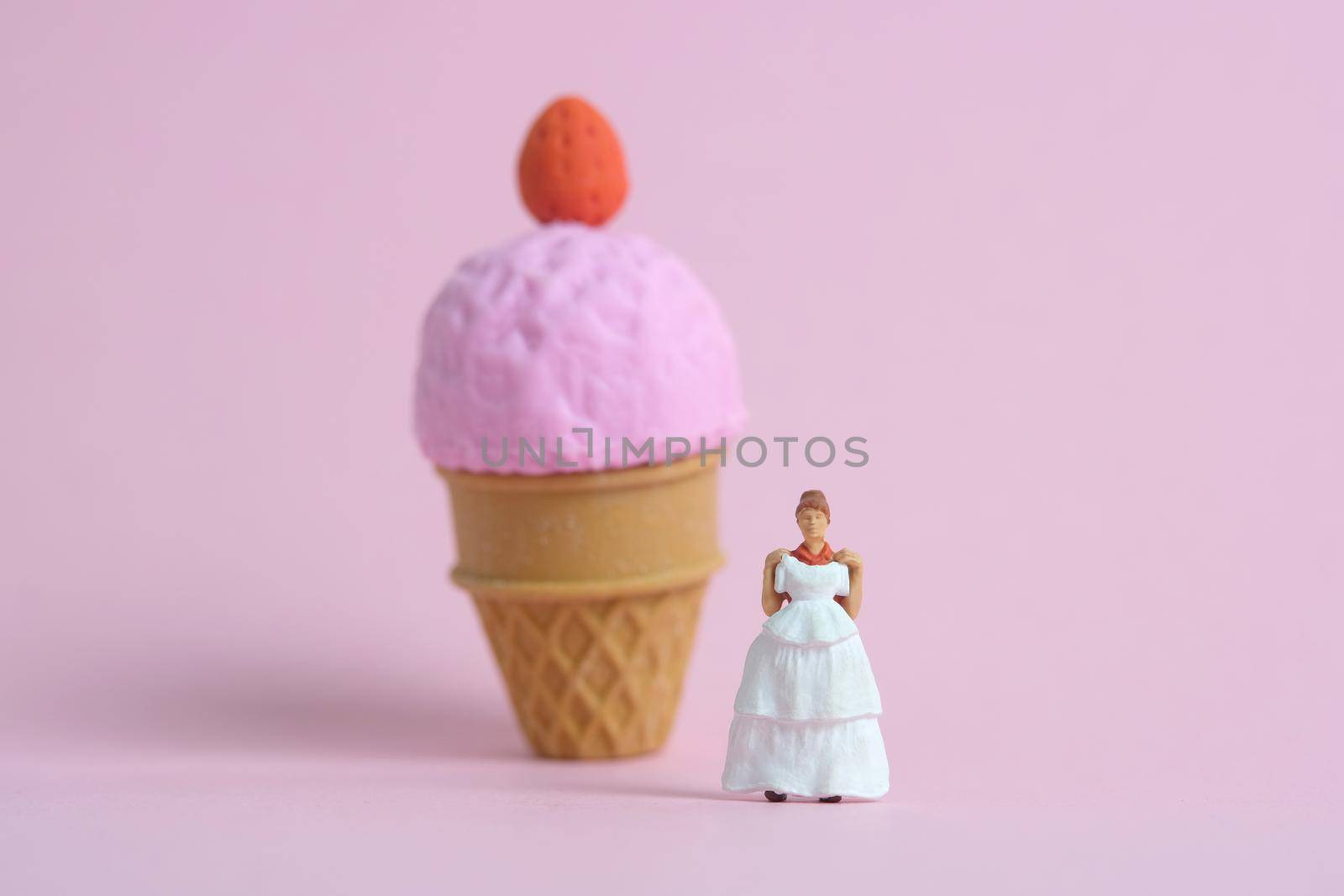 Woman dieting from ice cream and fat before wedding day concept. Miniature people toys photography, girl holding wedding dress. Image photo