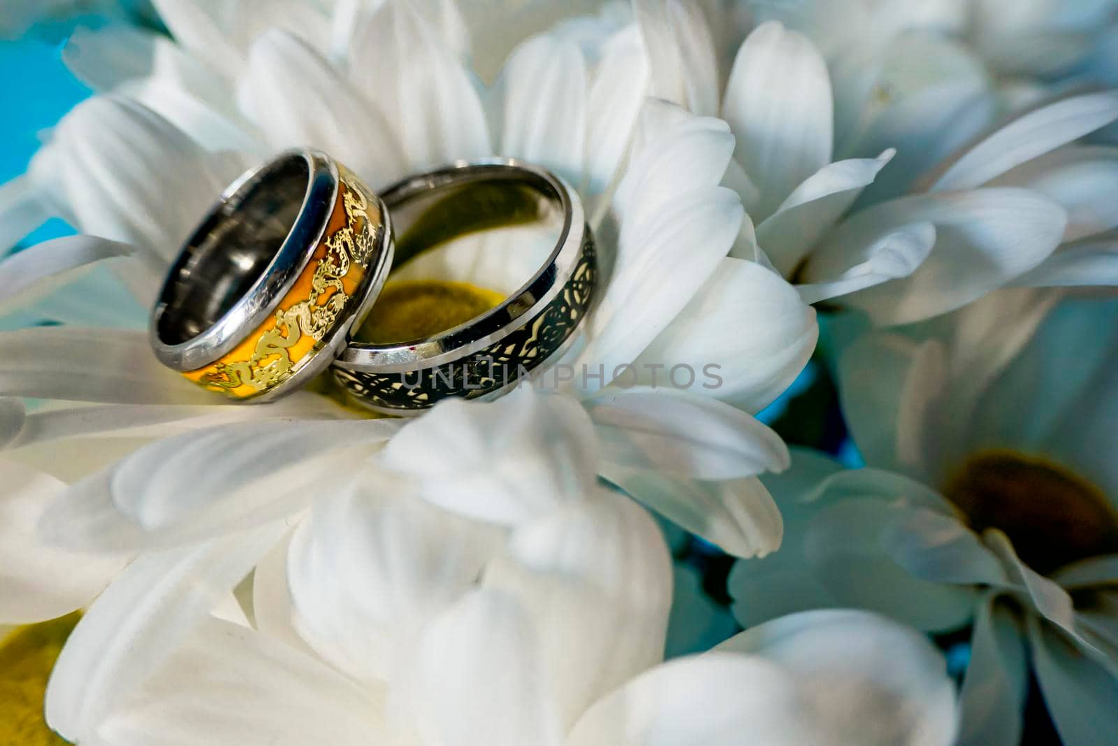 Wedding rings surrounded by various wedding details. by kajasja