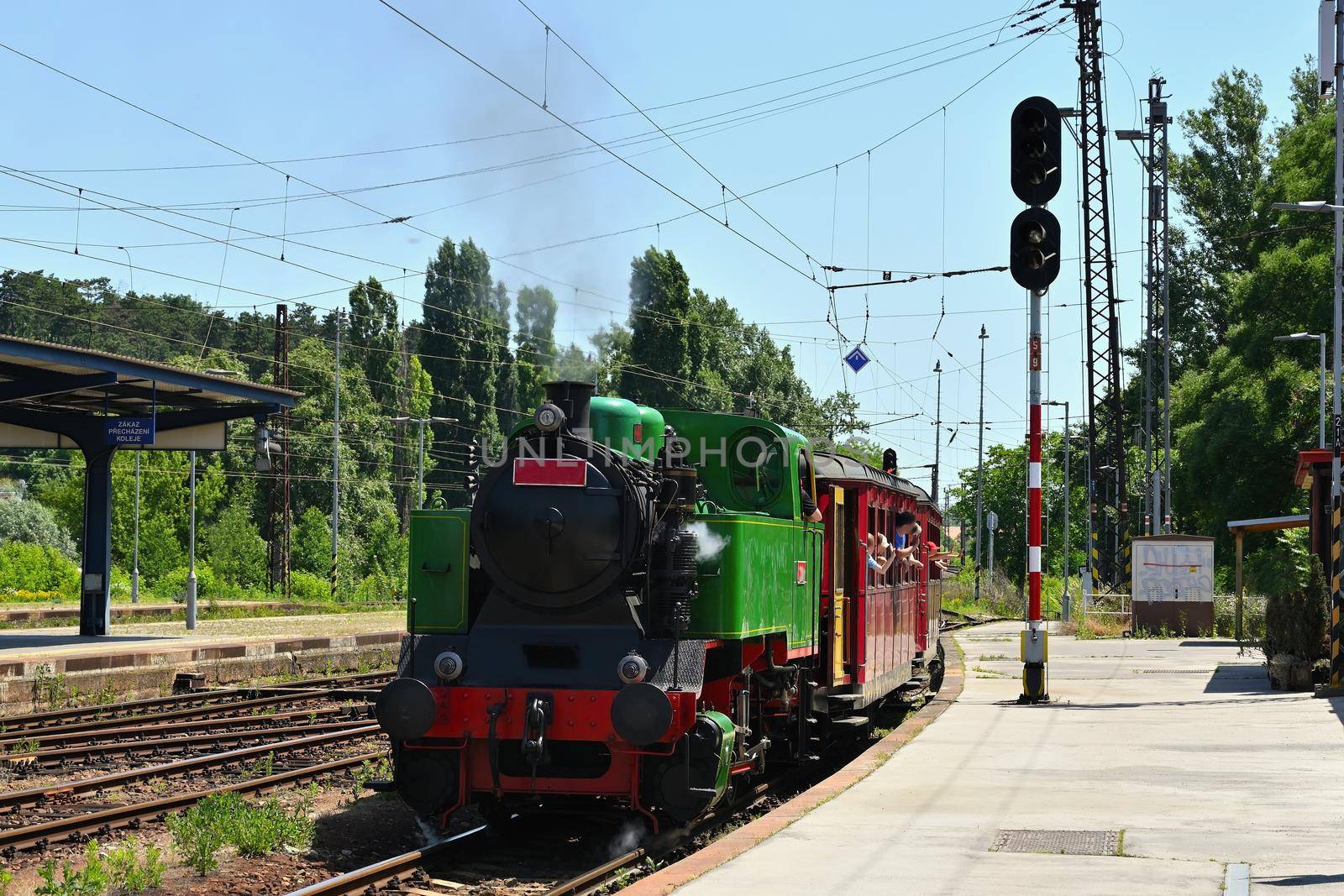 Beautiful old Czech train with steam locomotive. Concept for retro, travel and train travel. Train tracks and a cruise train in the countryside.