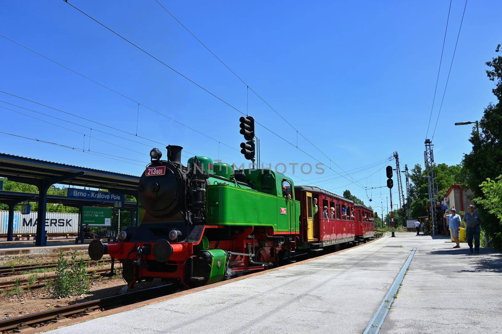 Brno - Czech Republic. June 18, 2022. Beautiful old Czech train with steam locomotive. Concept for retro, travel and train travel. Train tracks and a cruise train in the countryside.