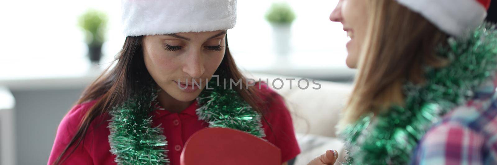 Female in santa claus hat open empty box, no present, practical joke by kuprevich