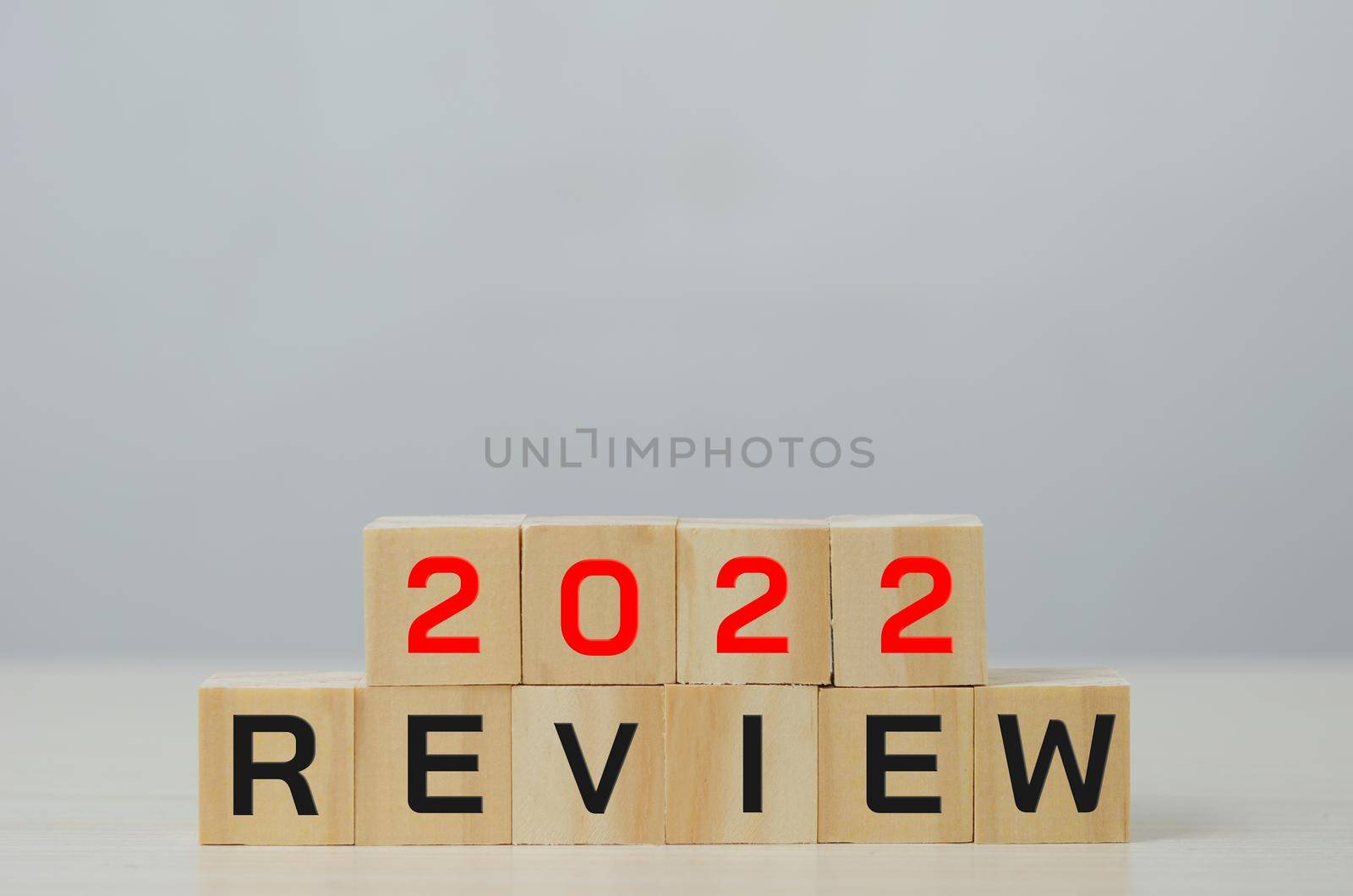 Wooden cube with 2022 review. Business concept of planning.Copy space.