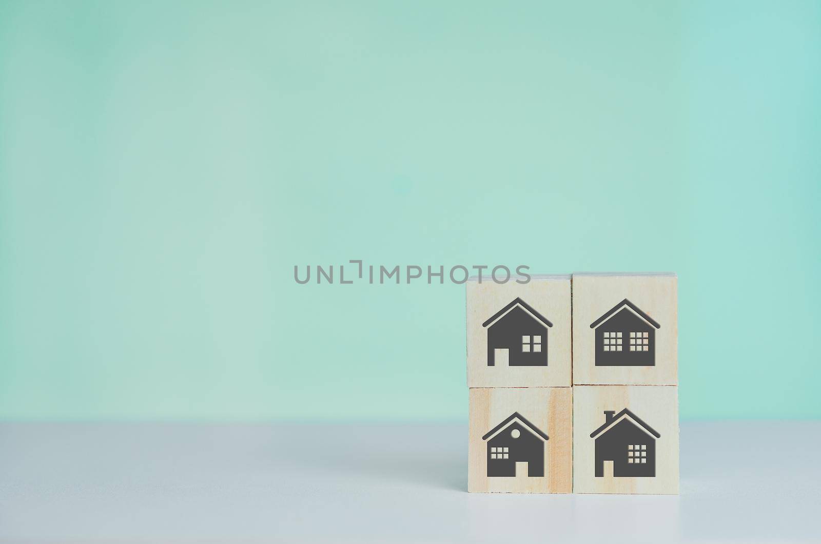 Wooden cubes with selling and renting houses or real estate concept property online symbol on background and copy space.