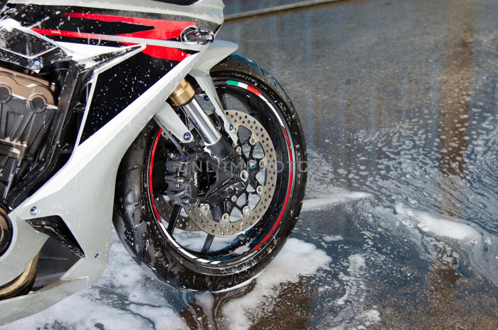 Cleaning the motorbike at the car wash shop