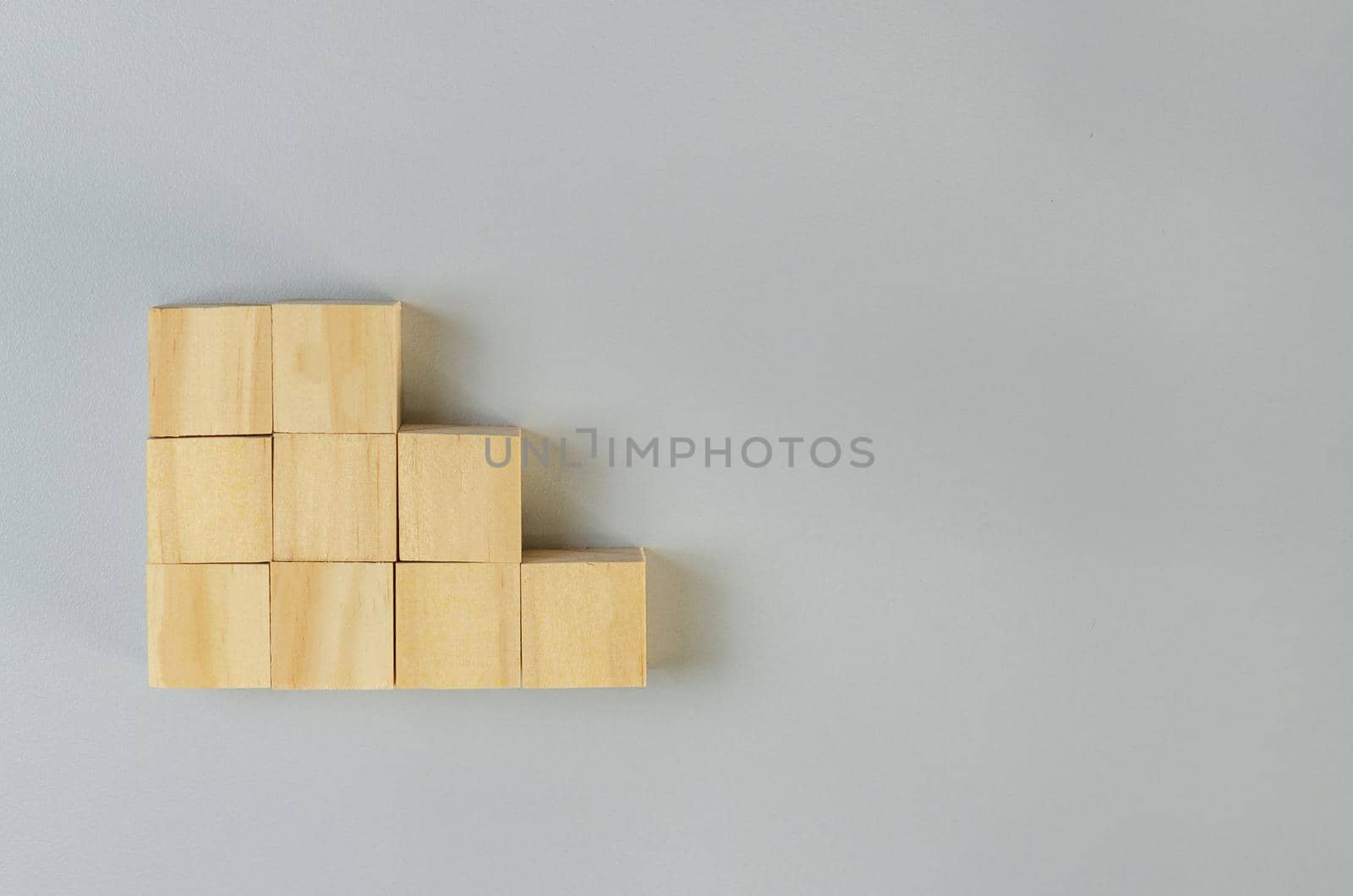 Blank wooden cubes for icons or symbols on gray background.
