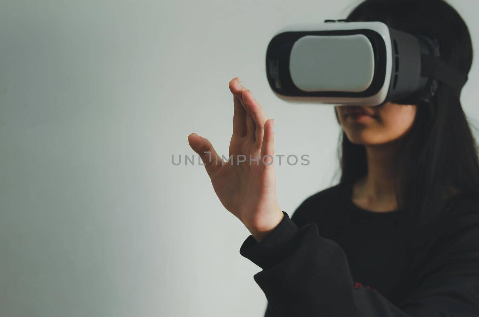 girl wearing reality glasses, vr box. Focus hand.