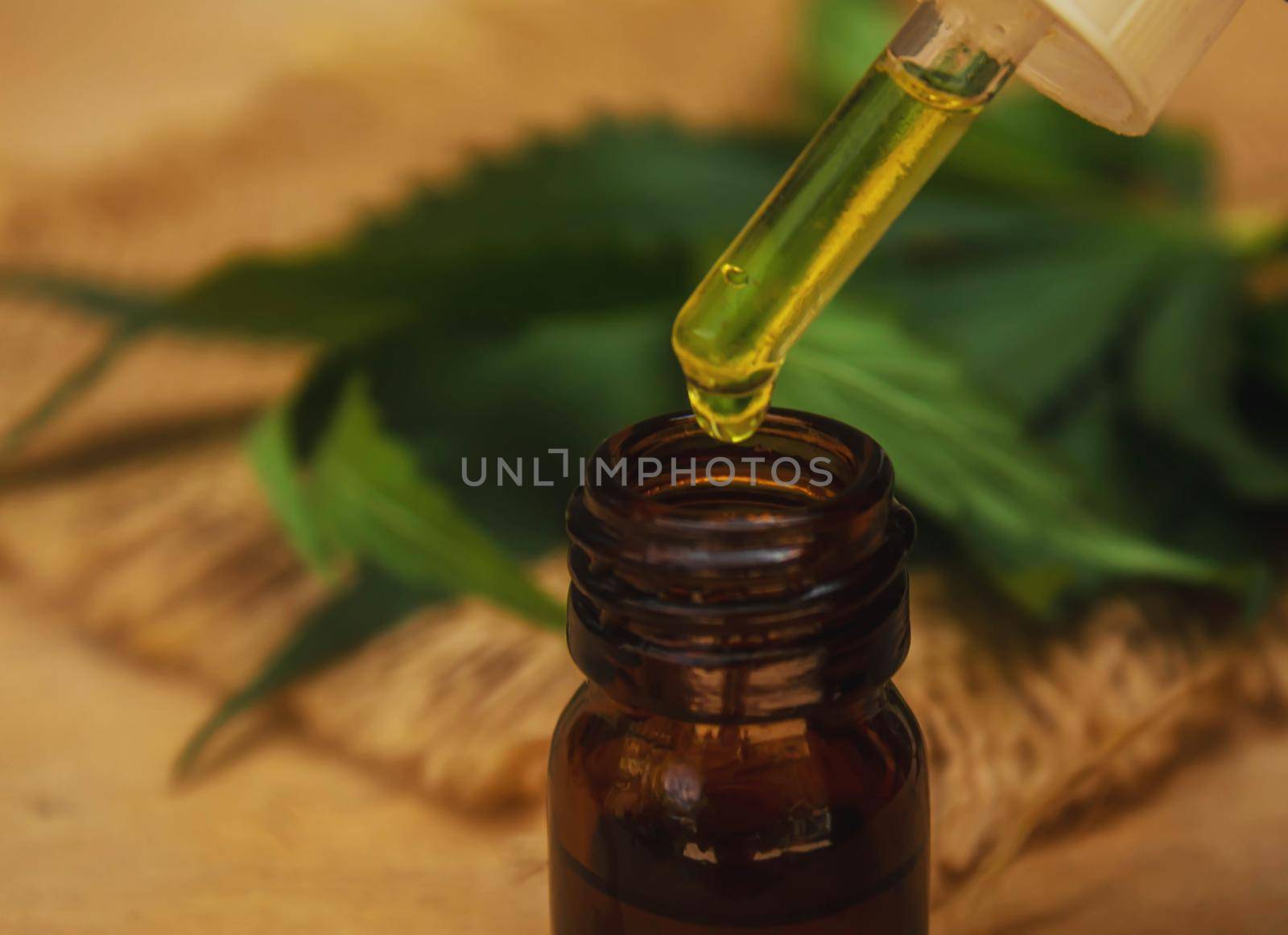 Cannabis essential oil in a small bottle. Selective focus. nature.