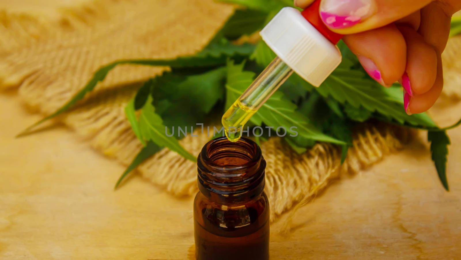 Cannabis essential oil in a small bottle. Selective focus. by mila1784