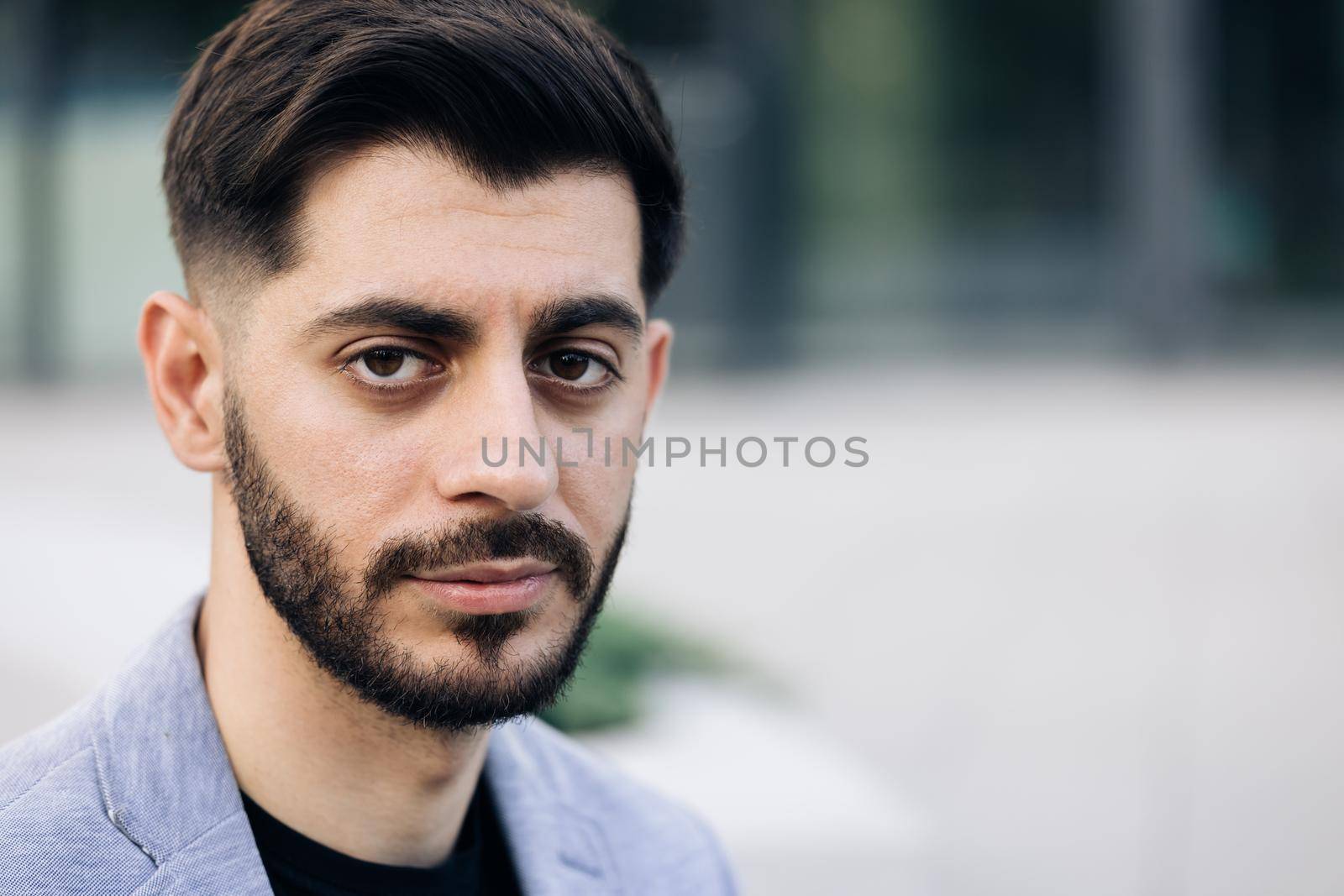 Close-up portrait of nice-looking caucasian multi-race beautiful businessperson elegant young man looking into camera. Career people. Fashion, beauty. Male portraits