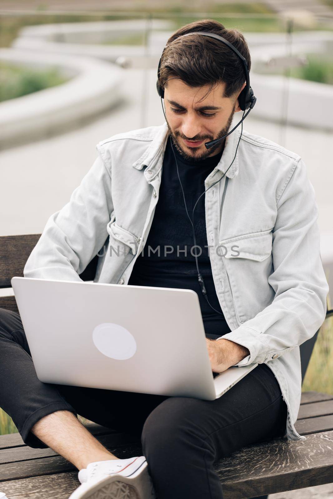 Business man wearing headphones communicating by video call. Ethnic businessman speaking looking at laptop computer, online conference distance office chat, virtual training concept.
