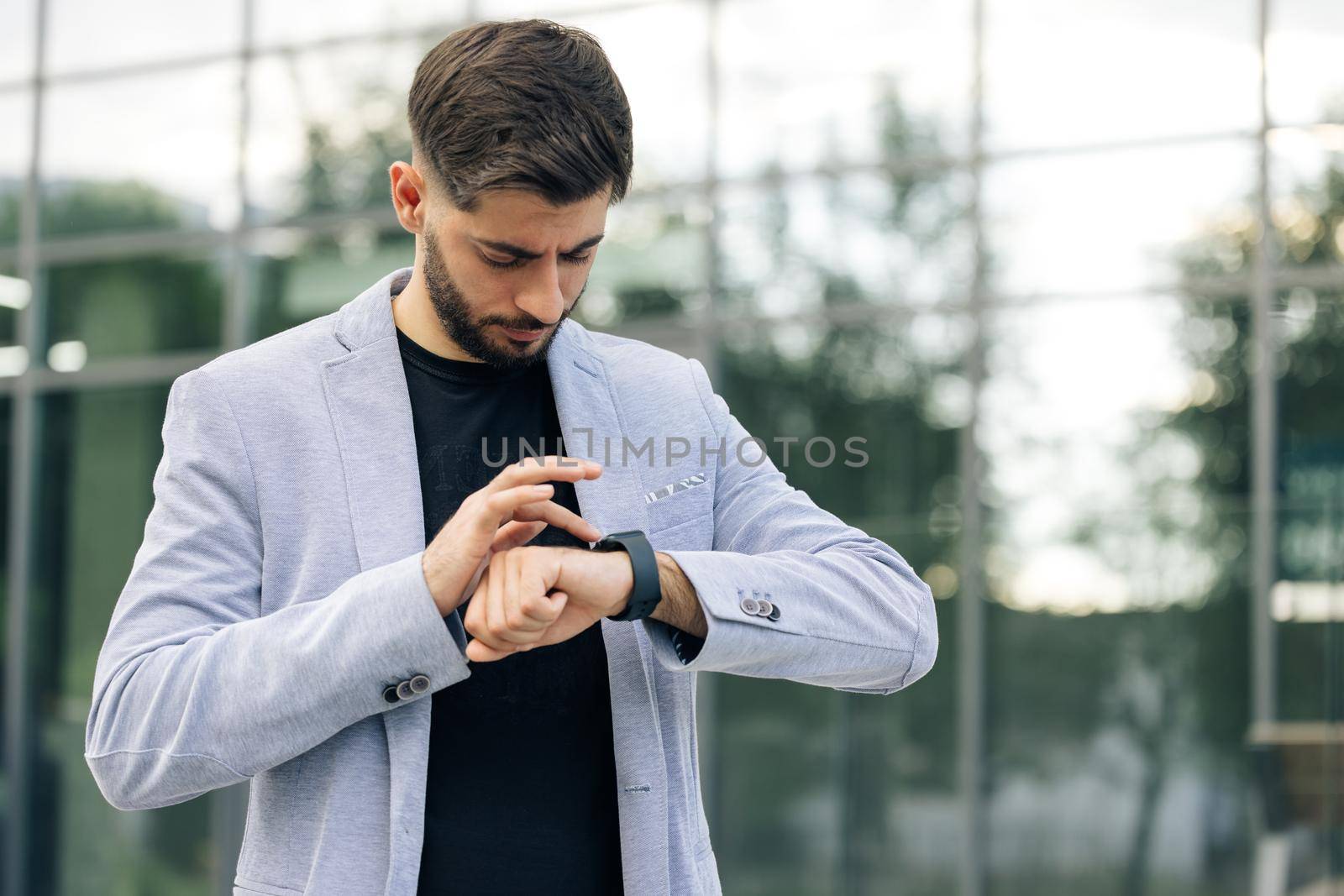 Businessman Scrolling On Display On Smartwatch Notification. Bearded Man Using Smart Watch Wearable Wristband Device. Male Checking Pulse Smartwatch App. Touch Screen Wearable Technology Smart Band by uflypro