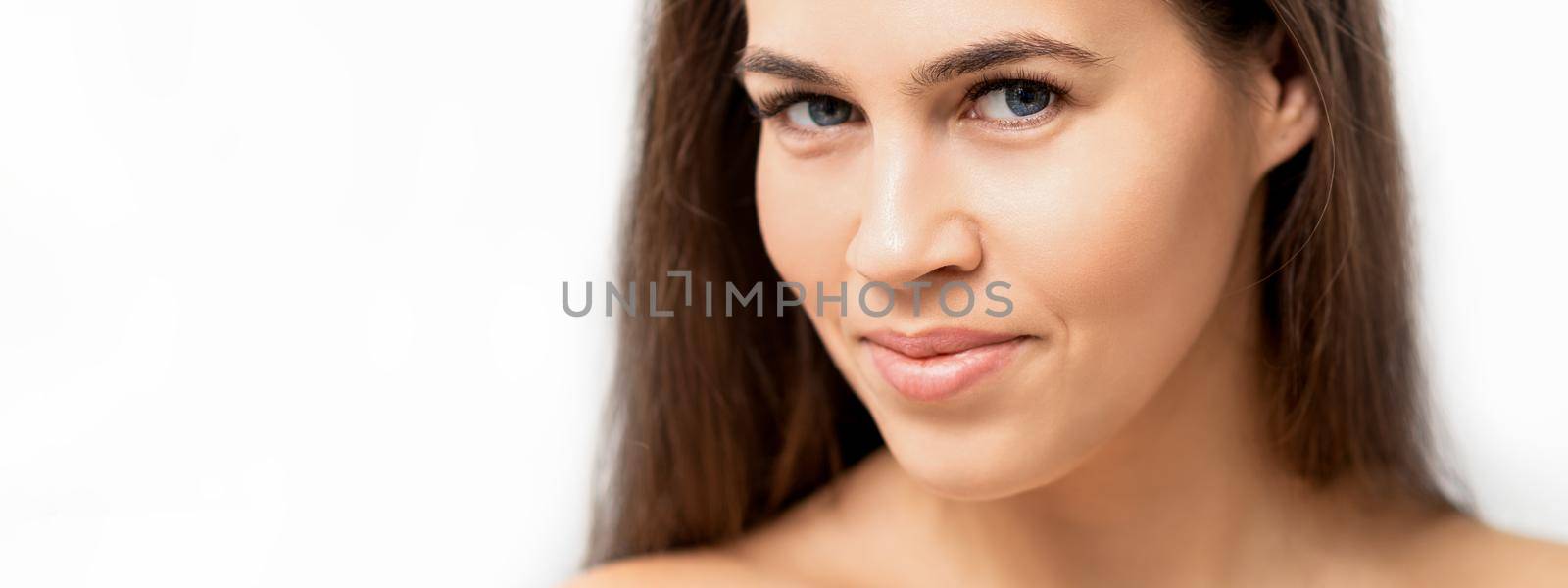 Young caucasian woman beauty face portrait with healthy white skin isolated on white background