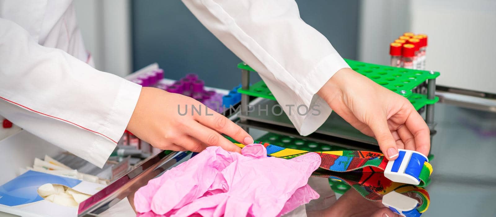 Female doctor's hands prepare tools for blood sampling in the lab