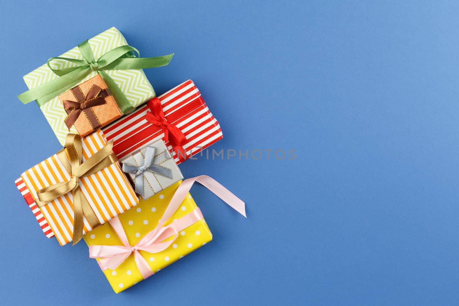 Paper wrapped gifts with satin ribbons. by alexxndr