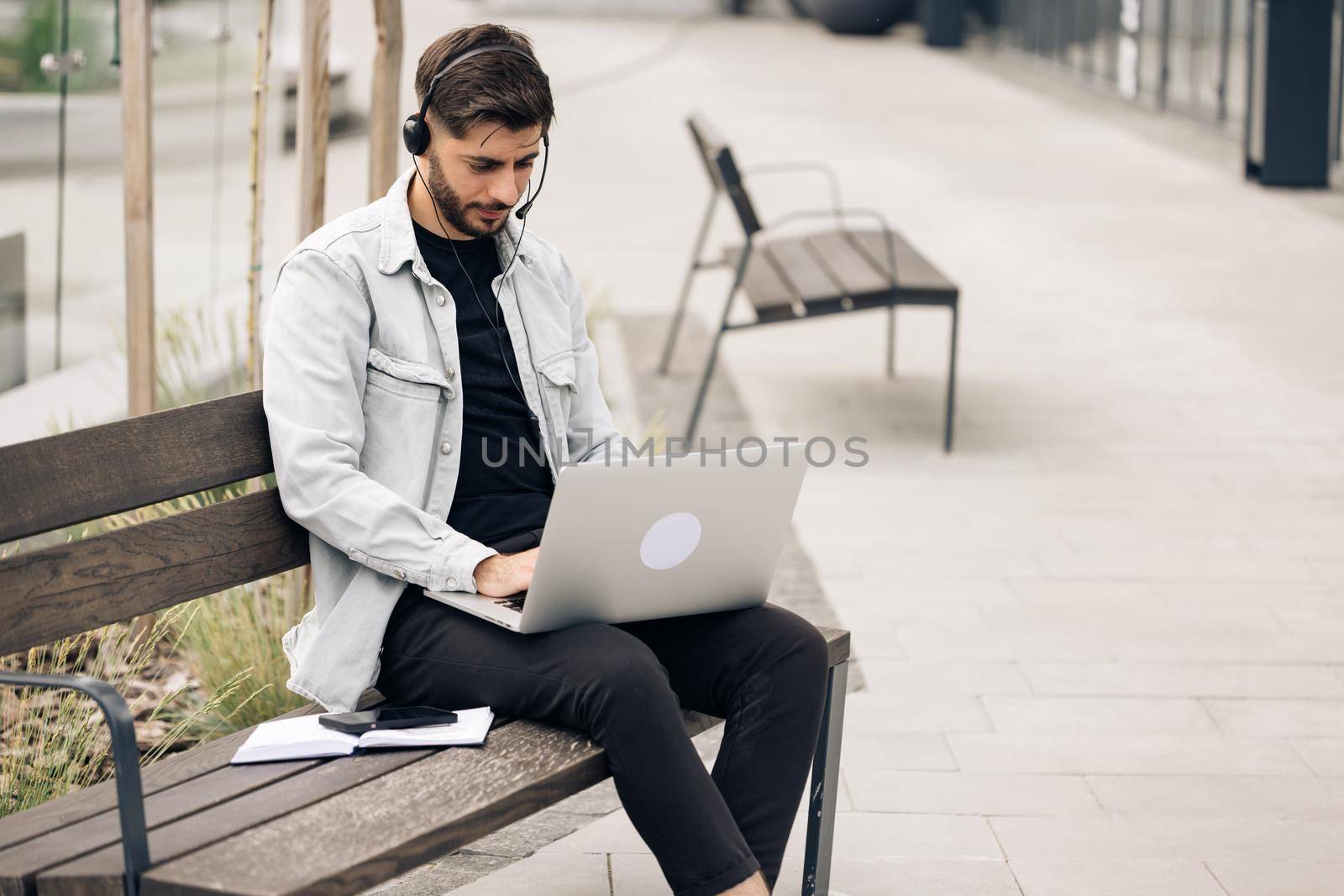 Caucasian business man wearing headphones communicating by video call. Ethnic businessman speaking looking at laptop computer, online conference distance office chat, virtual training concept by uflypro