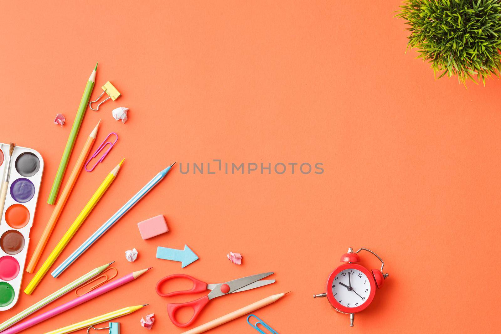 Paints, colored pencils, scissors, paper clips, rubber bands. Painting tools. Stationery. Bright collage, top view concept of a creative work table.