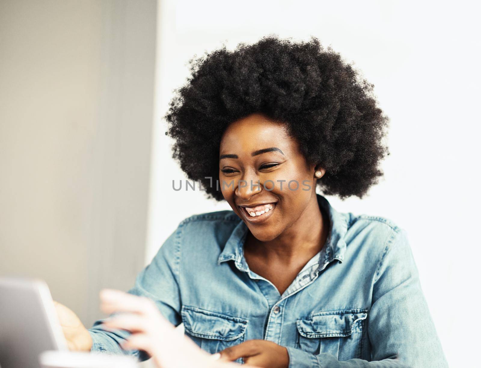 Attractive african american business woman in a modern office or a student in a classroom