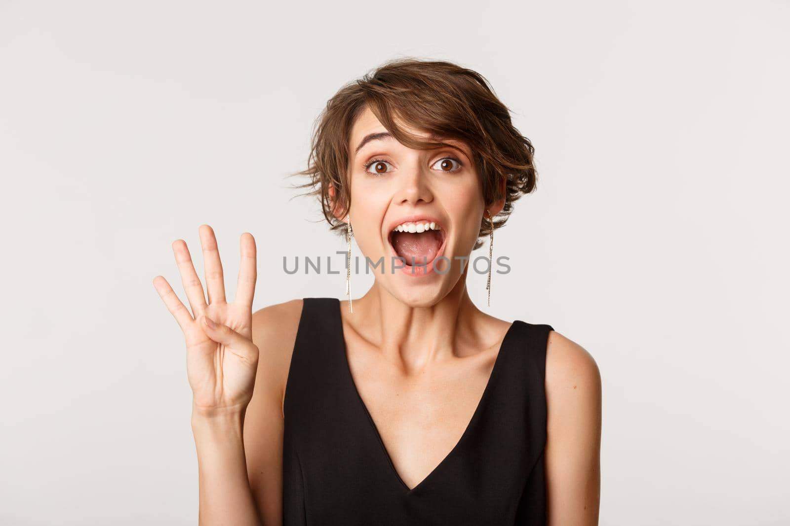 Close-up of excited attractive woman showing number four and smiling.