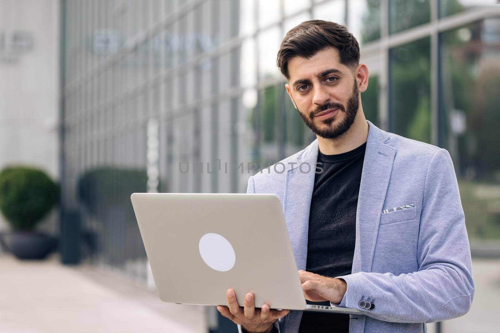 Bearded businessman professional financial advisor, executive leader, manager, male lawyer or man entrepreneur standing in office posing for headshot business portrait by uflypro