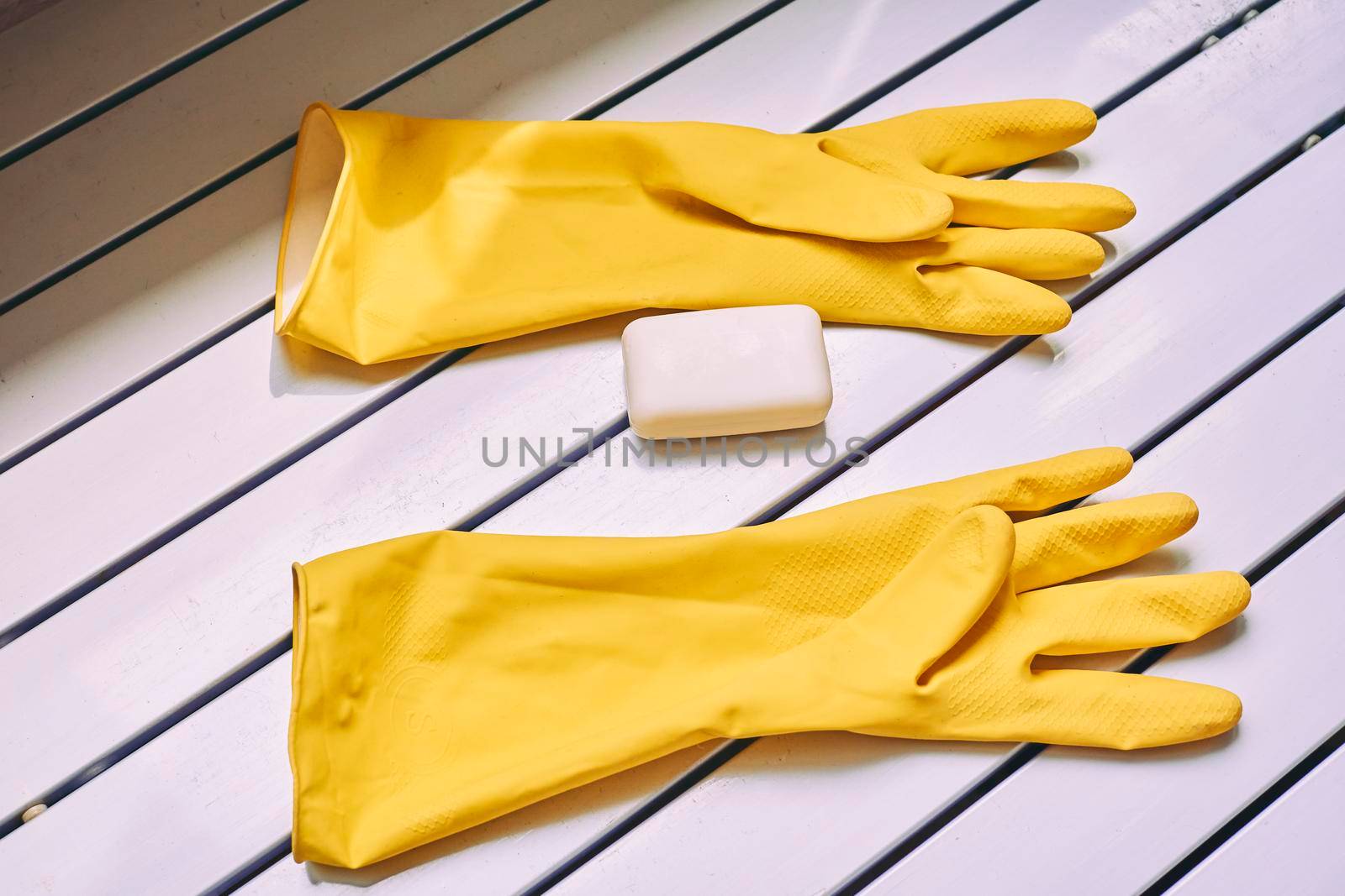 Rubber yellow protective gloves and soap. A set for washing anything by jovani68