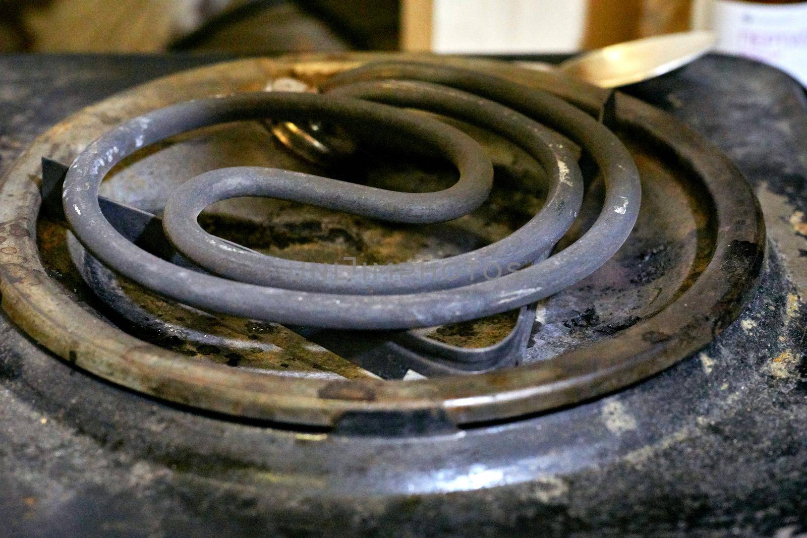 Spiral of an old dirty electric stove for cooking or heating food by jovani68