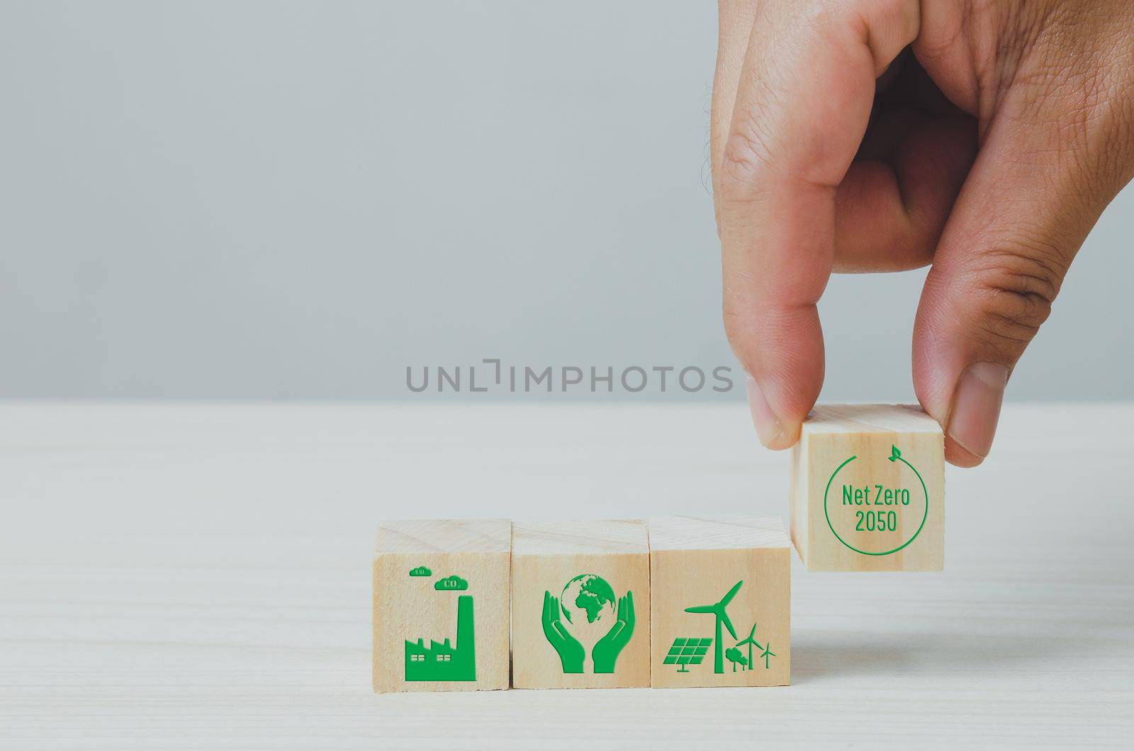 Wooden cubes with net zero and carbon neutral green factory icon symbol background and copy space. by aoo3771