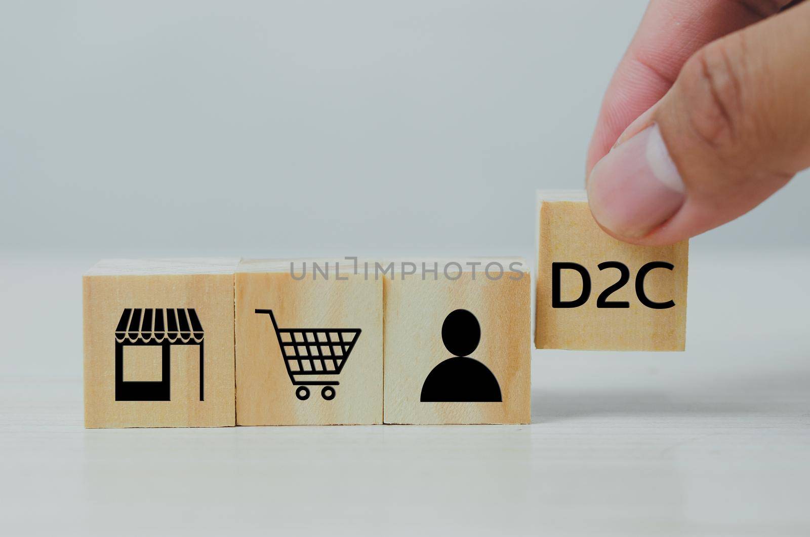 Hand put wooden cubes with Direct to Consumer D2C on table and copy space.Business concepts. by aoo3771